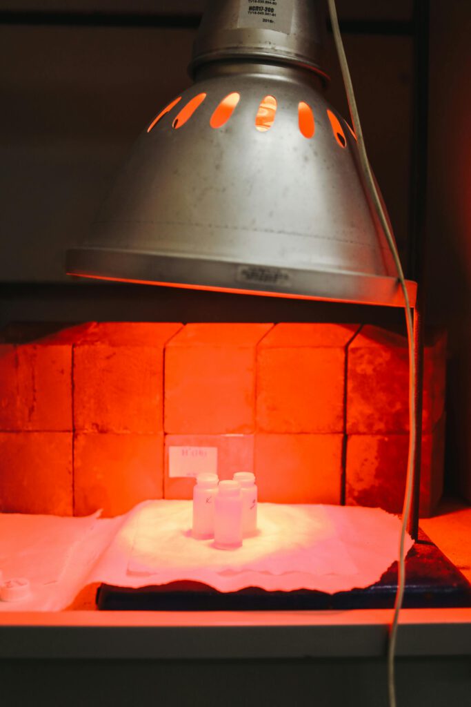 pexels-photo-3735774-3735774 Infrared lamp illuminating test samples in a laboratory setting, highlighting experimental research.