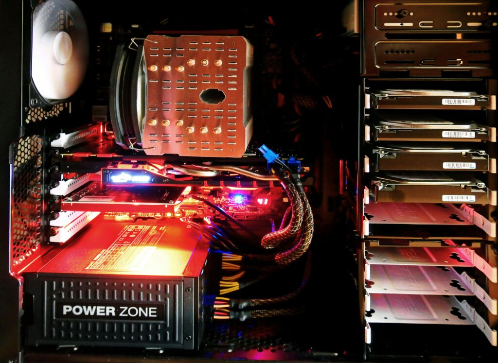 computer-technology-pc-electronics-159235-159235 Close-up of a custom gaming PC with RGB lighting, showcasing power supply and components.